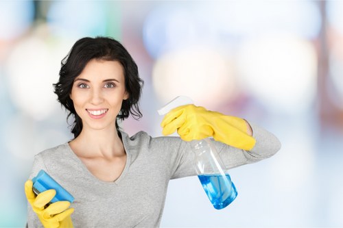 Local technician cleaning a corner sofa in a Watford property